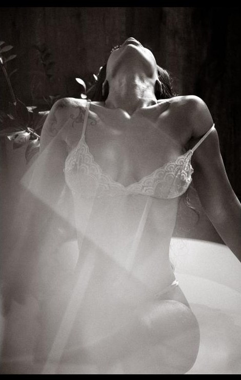 A relaxed model framed by spectral light from a handheld prism